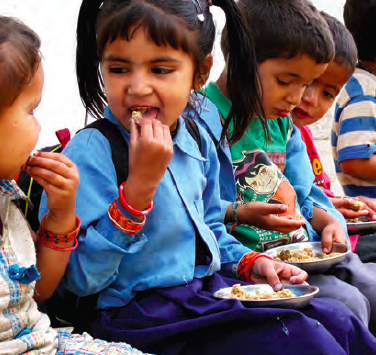 Primary school students receive nutritious mid-day meals of fortified wheat-soya, in Nepal