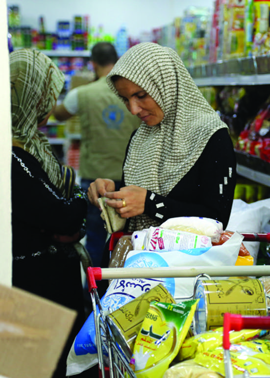 Syrian refugees go shopping with e-vouchers