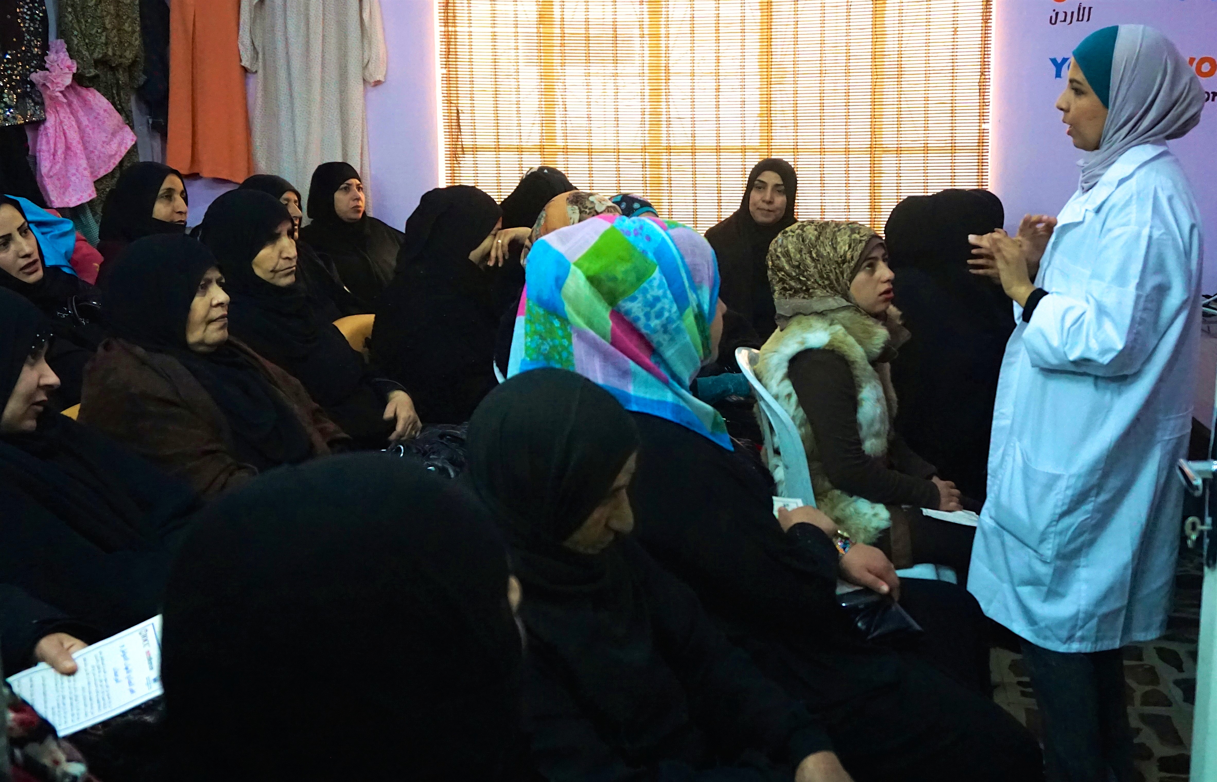 A health educator leads an awareness session for women
