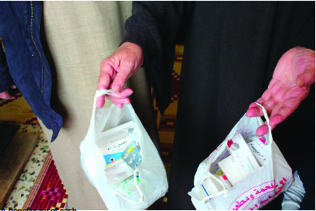 A beneficiary of cash assistance in Lebanon holds medications she was able to purchase