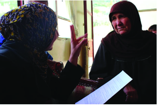 A beneficiary of cash assistance in Lebanon is briefed on the programme