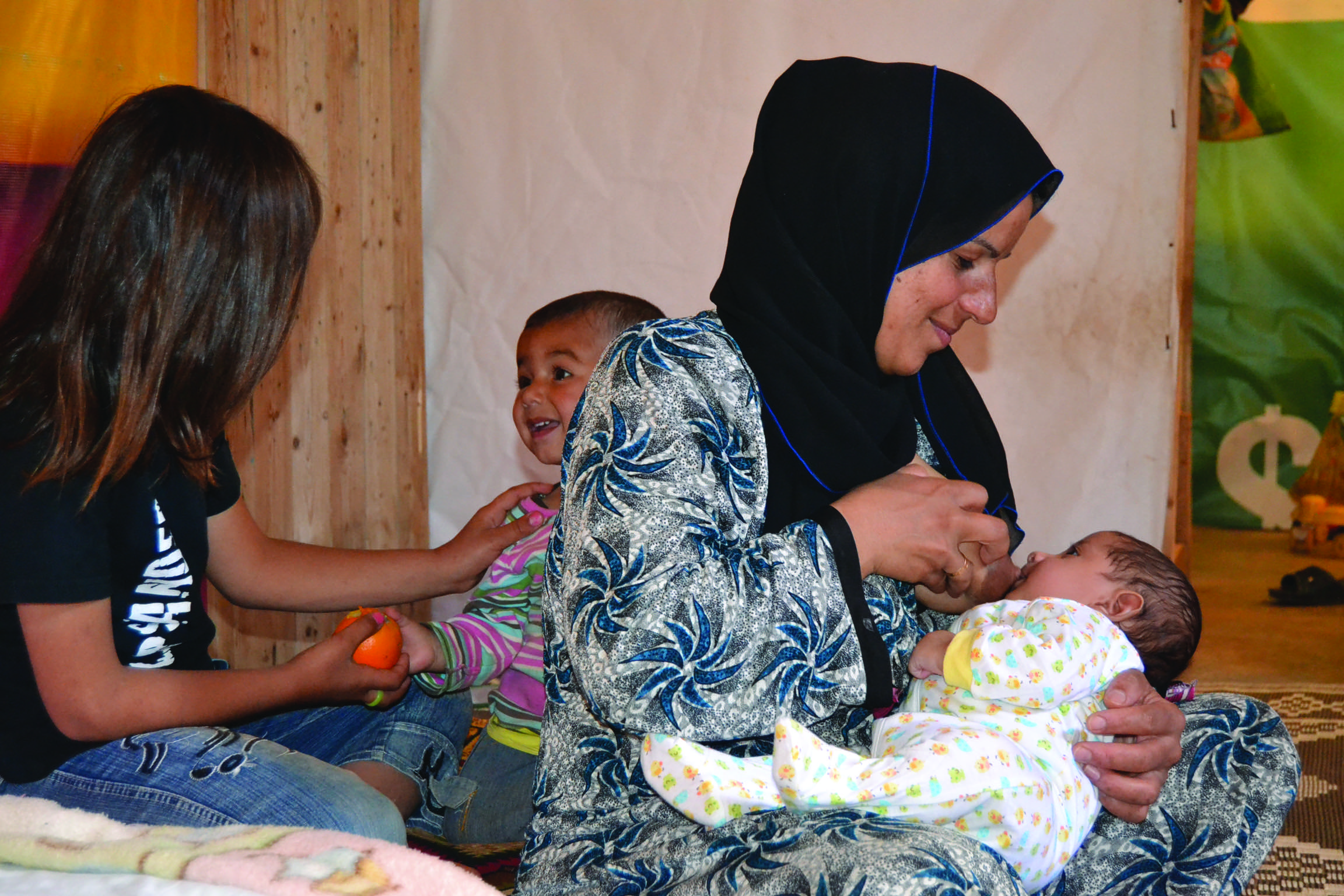 A Syrian refugee mother successfully breastfeeds her child after receiving individual counselling from an IOCC lactation consultant