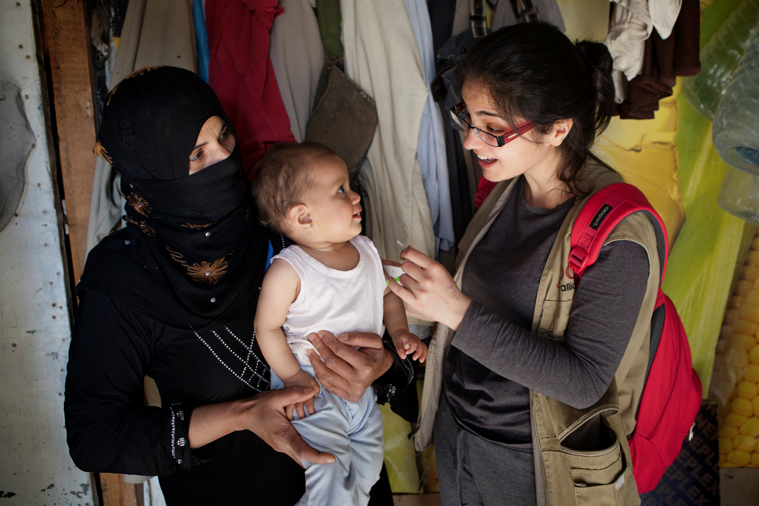 IOCC field officer screens a Syrian refugee child for malnutrition in the Bekaa valley