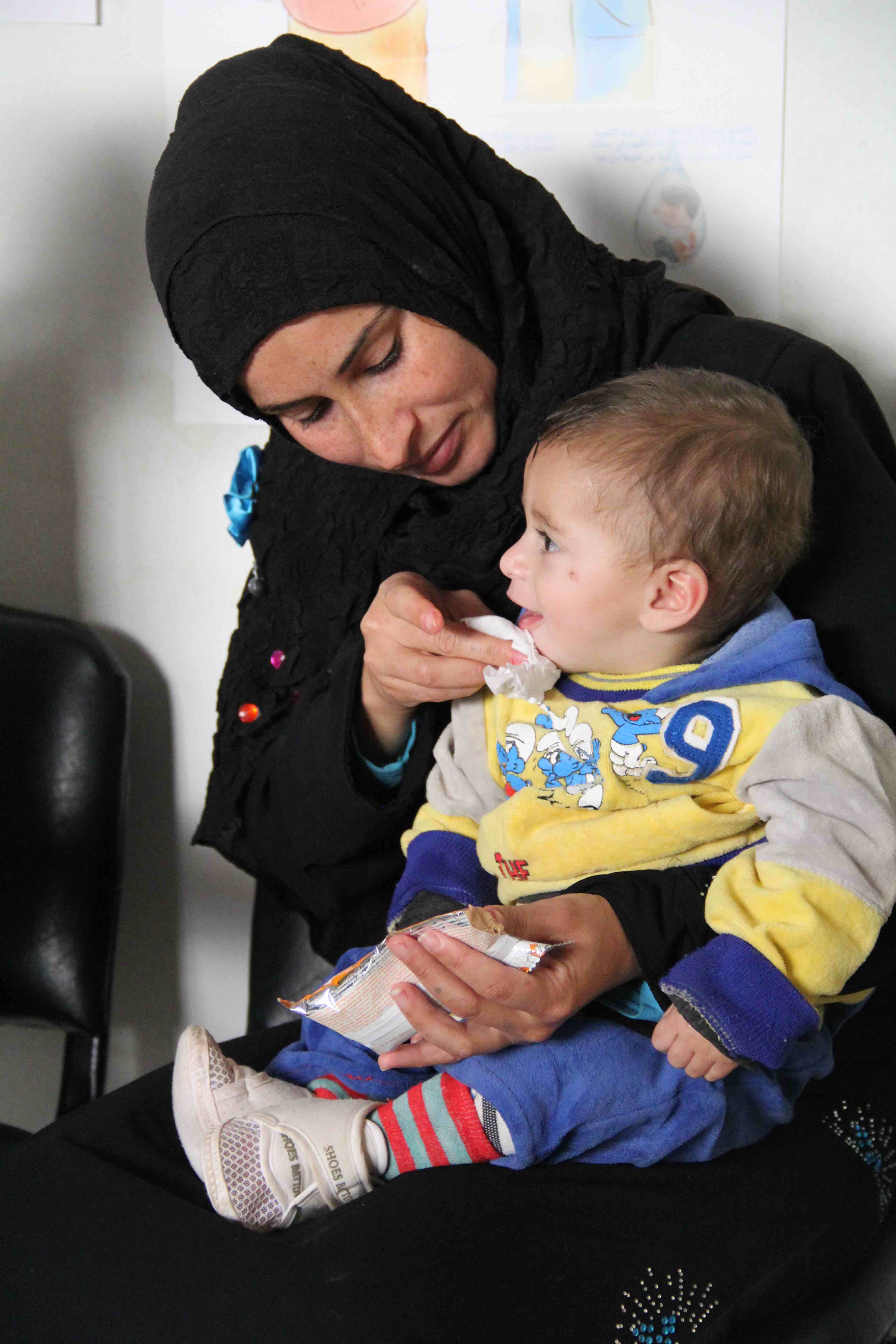 A child is fed RUSF for the treatment of malnutrition (Bekaa valley)