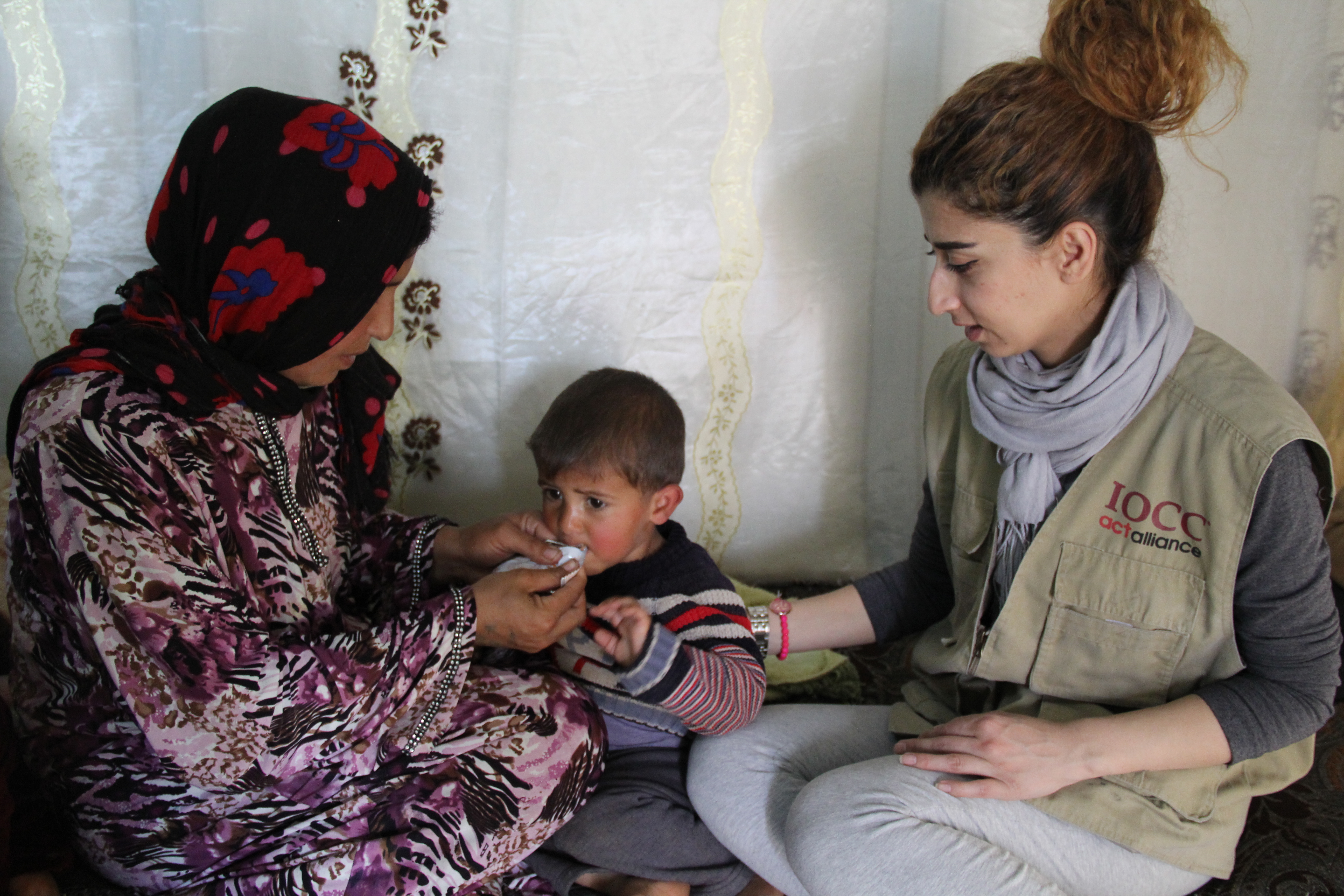 An IOCC field officer carefully monitors the malnutrition treatment of two and a half year old, Mataab, in the Bekaa valley