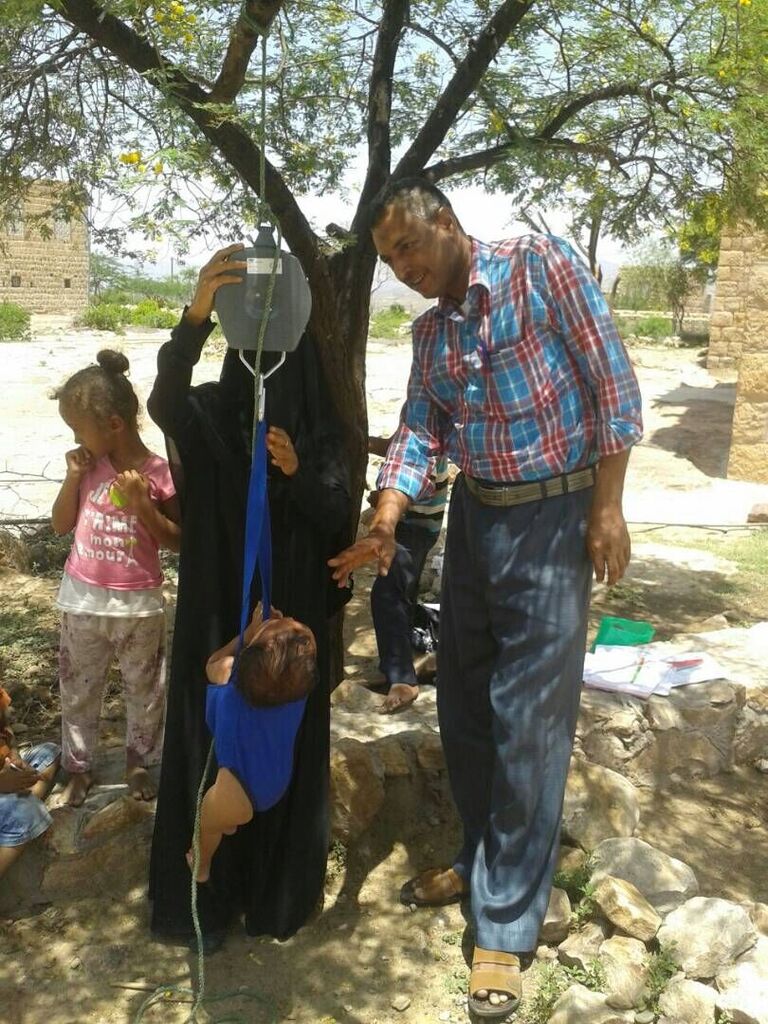 A community health volunteer conducts growth monitoring in the community in Taizz