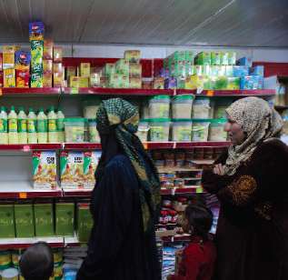 Women doing their own shopping using WFP/TRC electronic food vouchers