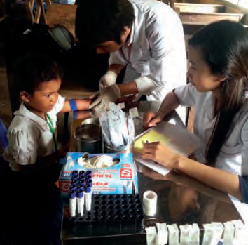 Taking blood samples to assess micronutrient status during a rice fortification trial in Cambodia