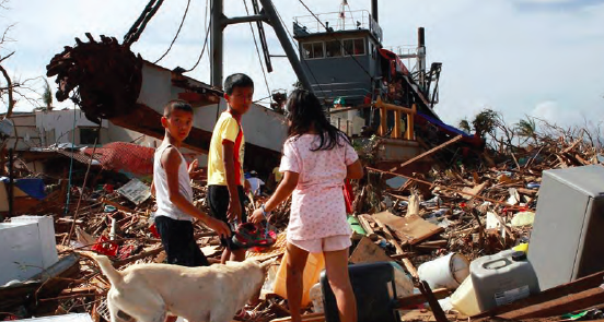 A dredging ship, carried inland by the Typhoon Haiyan, being used as a temporary shelter by more than 20 families