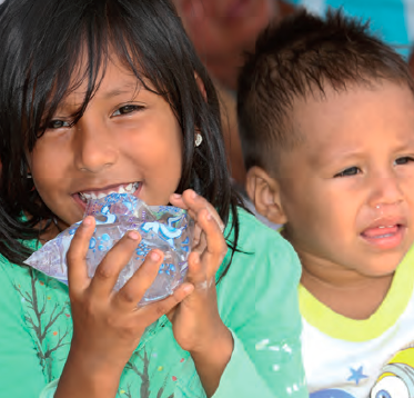 Girl drinking water at Nuevo Terminal Terrestre shelter