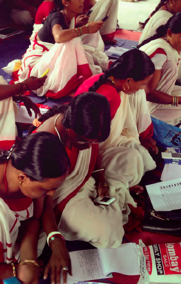 Anganwadi Workers being trained on using the customised mobile phone application for BCSP