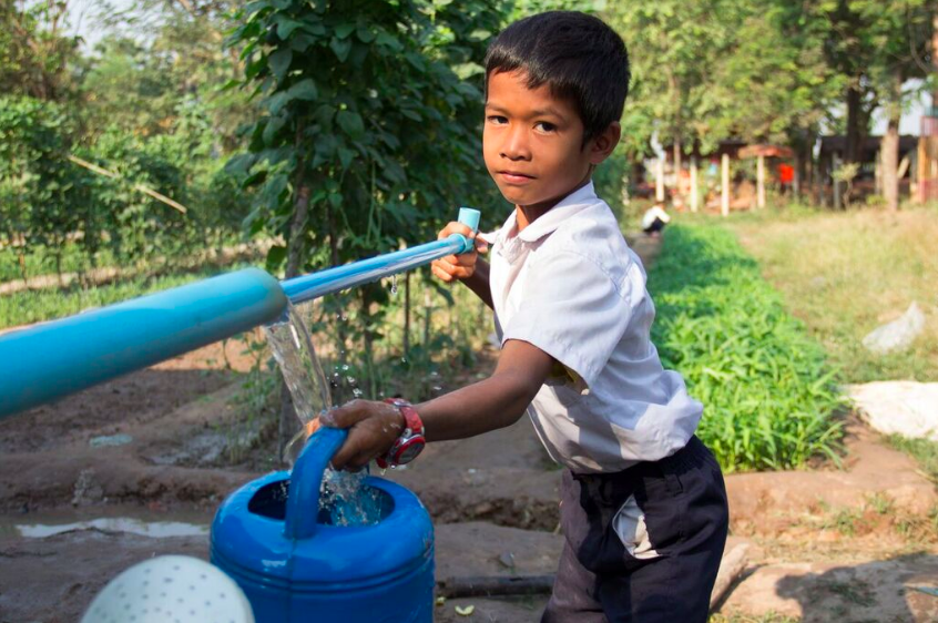A boy draws water in a home-grown school feeding programme in Siemp Reap Province, Cambodia, 2016