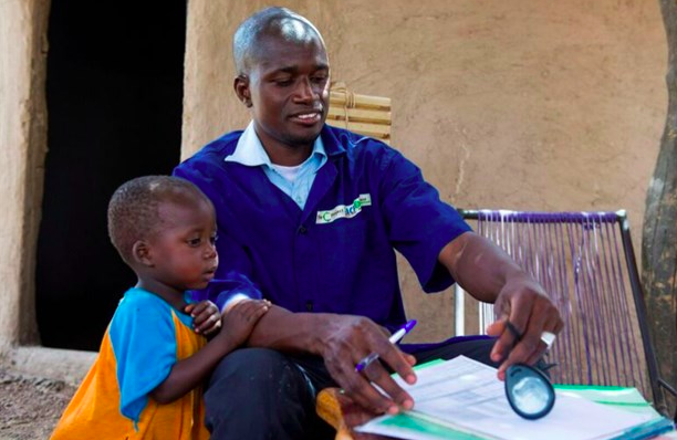 Famakan Kiabou, the community health worker in Kourounan, checks the medical records of Samakoun, Mali