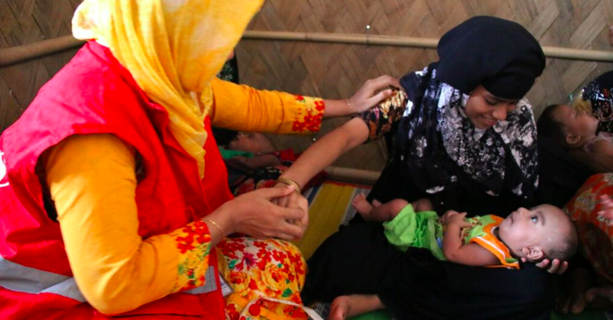 MAMI counsellor measures the MUAC of a mother whilst she holds her baby at a C-MAMI site, Cox's Bazar, Bangladesh, 208 Daphnee