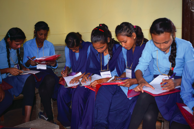 School girls answering a health and nutrition survey for the adolescent programme