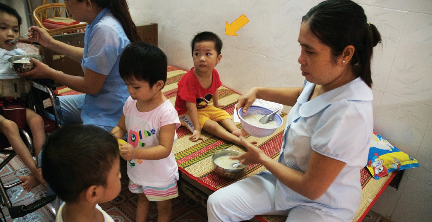 Children being fed at a government-run institution in Vietnam