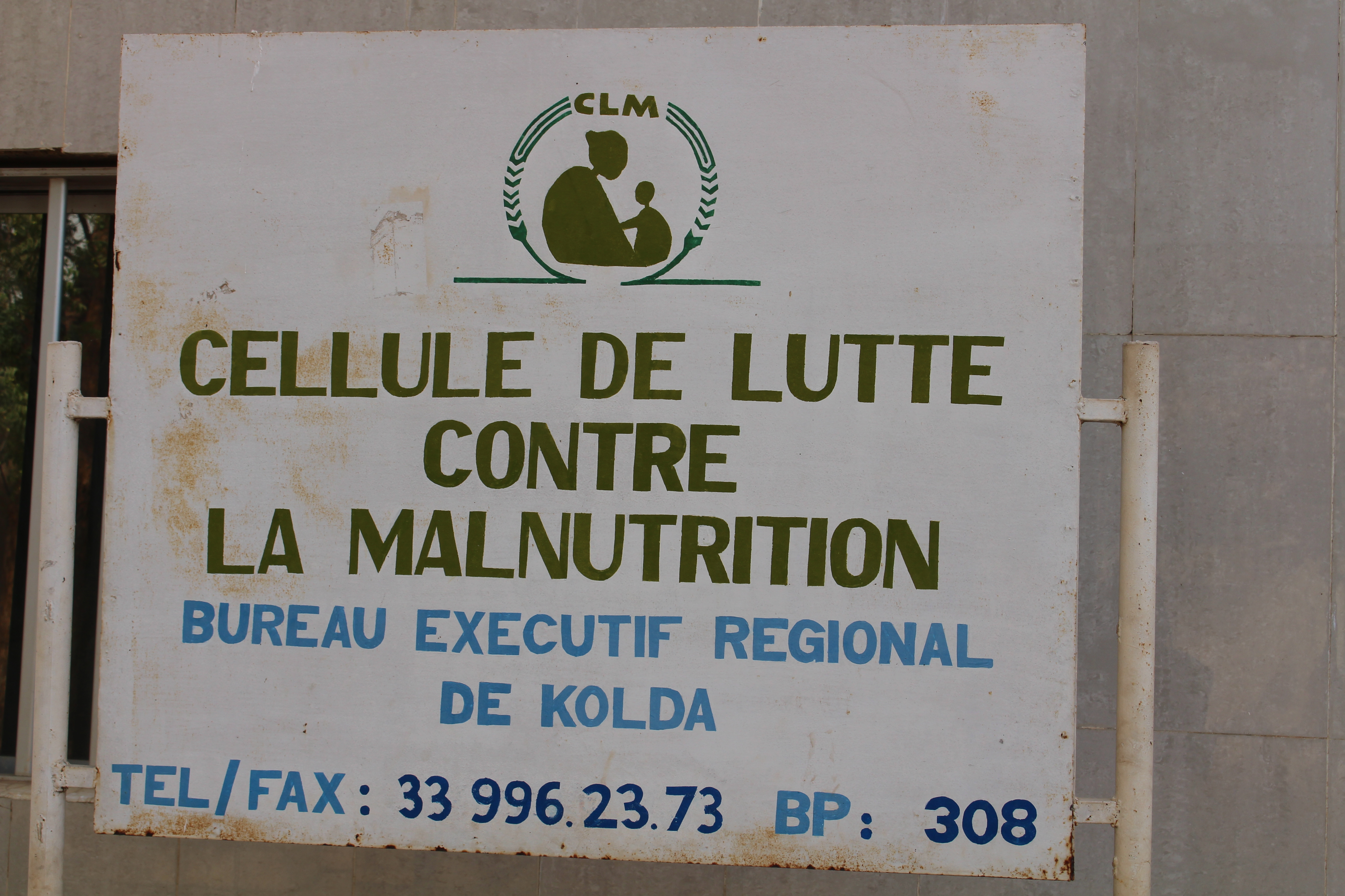 Image shows a sign reading "Cellule de Lutte Contre La Malnutrition.