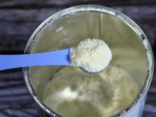 a photo of milk powder and a spoon