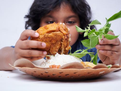 Boy in India holding his dinner