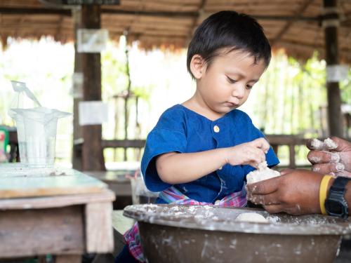 Cambodian boy preparing his meal
