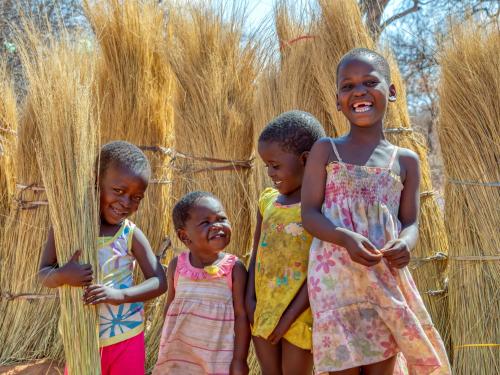 children smiling in a crop field