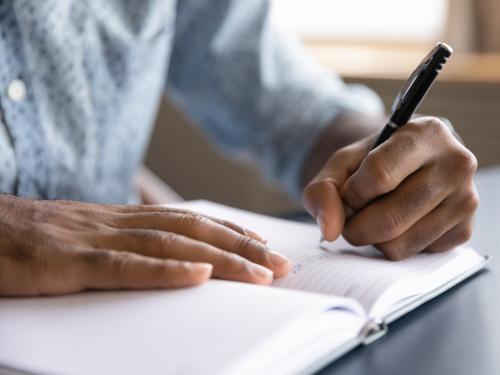 A photo of someone writing a letter