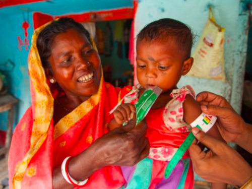 FB A child's MUAC is measured as her grandmother holds her by the CMAM District Coordinator Sudhakar, Bokaro, India