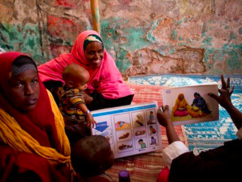 FB Women and young children attend a health education session at a UNICEF-supported outpatient therapeutic feeding c