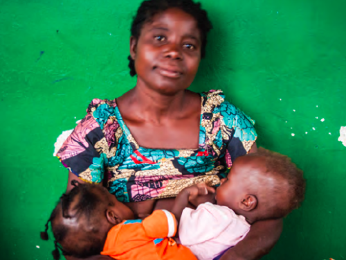 FB a woman breastfeeding two children