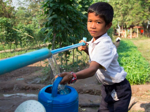 FB a boy draws water in a home-grown school feeding programme in Siemp Reap Province Cambodia 2016