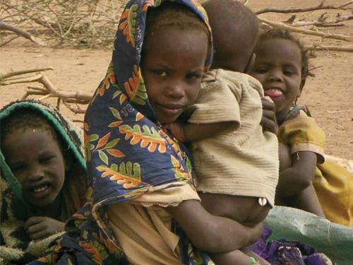 Front cover image shows a group of children, with one of the children holding a baby