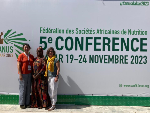 Our ENN representatives with Dr. Maimouna Diop Ly standing in front of the FANUS 5th Conference banner in Dakar
