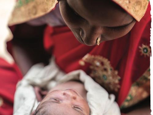 Photo of a woman in traditional Indian clothing looking at her baby