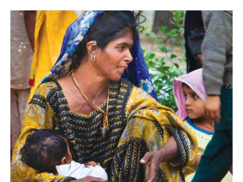 Front cover of report titled, "Mapping SUN Movement Networks in 17 fragile and conflict-affected states: A snap shot of developments and progress." Image shows a mother sitting down in a crowd holding her baby.