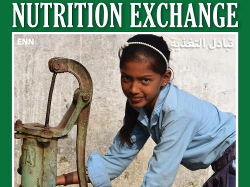 Front cover of Arabic version of Nutrition Exchange Issue 12. Image shows a school girl collecting water from a water pump.