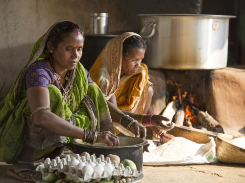 Image shows two women cooking with eggs.