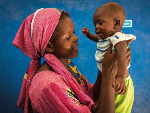 Mother holding baby up with both hands