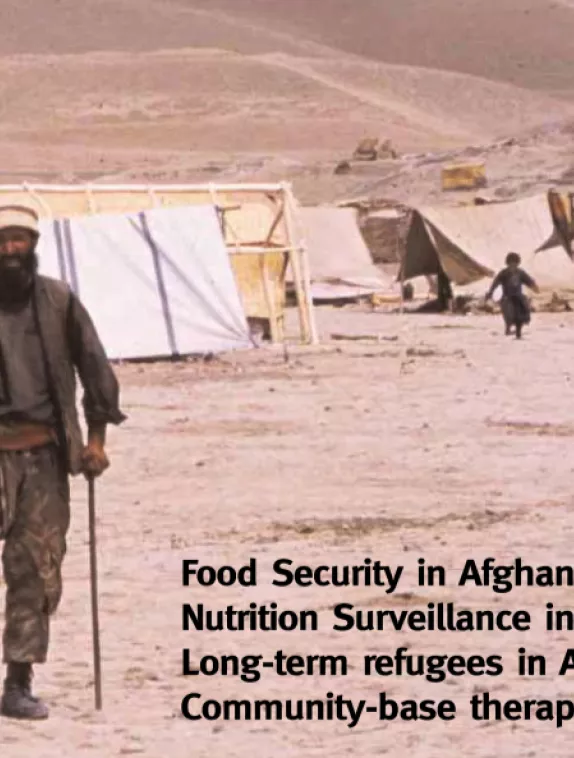 Front cover image shows a camp in Afghanistan with a man with one leg walking on crutches