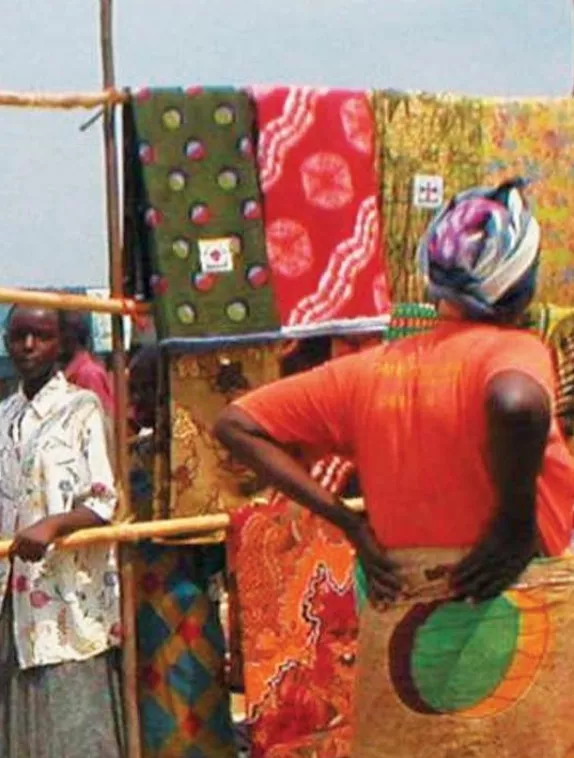 Front cover image shows a women standing in front of rails with hanging clothes and materials 