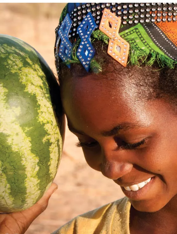 Front cover of issue 7 English version of Nutrition Exchange. Image shows a a girl smiling and holding a watermelon. 