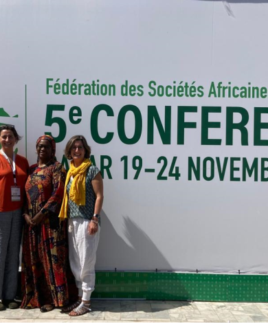 Our ENN representatives with Dr. Maimouna Diop Ly standing in front of the FANUS 5th Conference banner in Dakar