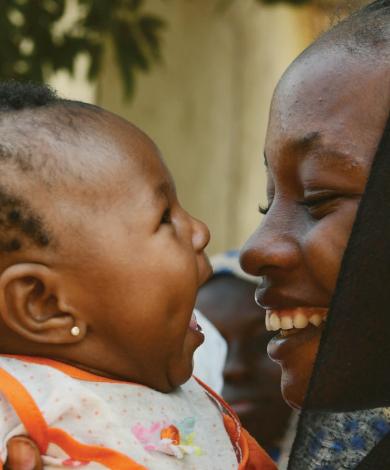 Front cover of article titled, "Best Practice in Preventing Child Wasting within the Wider Context of Undernutrition: A Briefing Note for policy makers and programme implementers, June 2021." Image shows a smiling woman holding a baby up to her face.