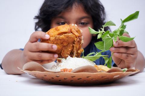 child holding his dinner