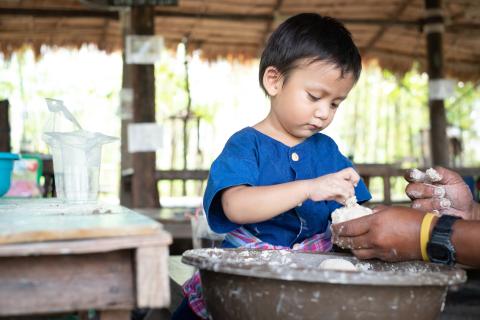 A boy preparing his lunch in Cambodia