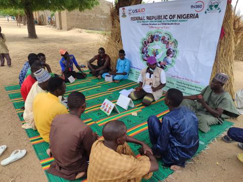 men sitting in a circle participating in a father to father support group