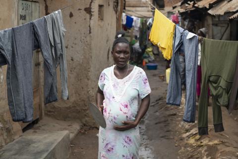 Pregnant woman in Burkina Faso standing under washing lines