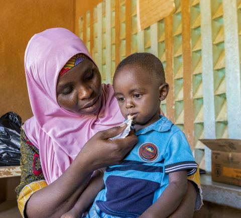 Woman feeding child in Niger