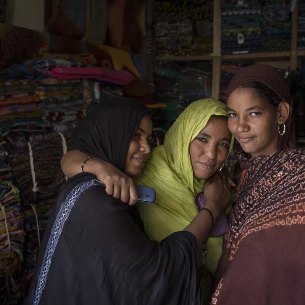 Three adolescent girls in a fabric store.