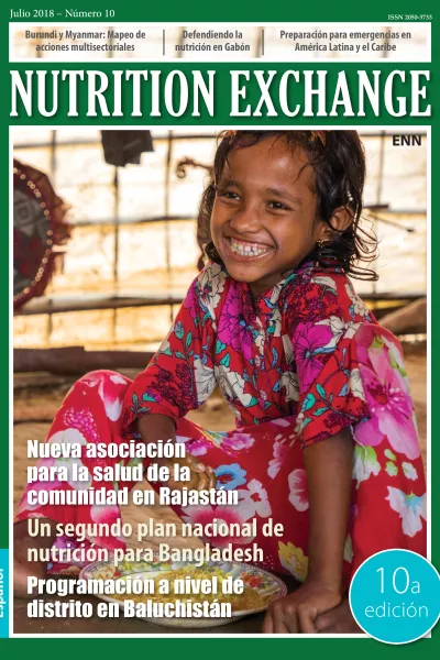 Front cover of Nutrition Exchange Spanish version of issue 10. Image shows a young girl eating from bowl and smiling.