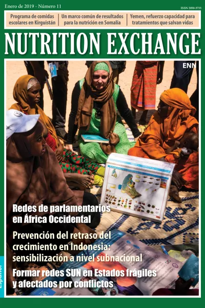 Front cover of Issue 11 Spanish. Image shows a group of women sitting and learning about nutrition.